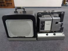 A Bell & Howell projector in case and a speaker in case (2)