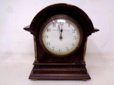 An antique mahogany and brass cased mantel clock retailed by Bravington Ludgate Hill, Kings Cross.