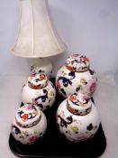 A tray containing four Masons Mandalay ginger jars together with a matching table lamp with shade