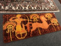 A 1970s wool rug. 69 cm x 174 cm.