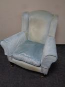 A Victorian style wingback armchair in blue upholstery