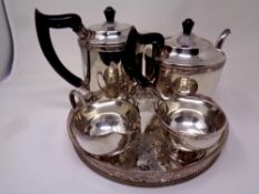 A four piece Viners silver plated tea service on circular tray