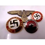 Four German military badges bearing Swastika.