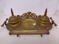 A decorative brass twin inkwell desk stand