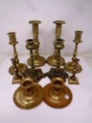 Five pairs of antique and later brass candlesticks