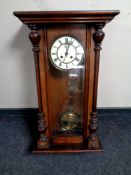 An Edwardian mahogany cased day wall clock with pendulum and key