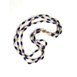 A triple strand pearl and lapis lazuli necklace with gold catch and gold beads