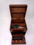 An early 20th century electric shock therapy machine in a fitted mahogany box