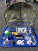 A brass and glass curio cabinet containing the curio cabinet cat collection