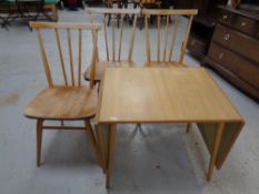 A set of three Ercol elm and beech spindle back dining chairs together with a 20th century flap