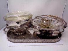 A silver plated twin-handled serving tray and assorted plated wares including dishes, baskets,