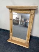 A stripped pine hall mirror with shelf.