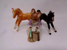 A Beswick Beatrix Potter figure, Hunca Munca sweeping together with two further Beswick figures,