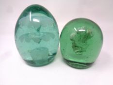 A Victorian green glass dump with flower sulphide together with a similar example with Prince of
