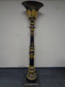 A decorative black and gilt floor standing uplighter