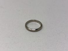 A platinum band ring, size G.