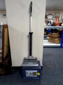A digital safe with key and a G tech Air Ram cordless floor sweeper