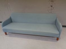 A 20th century Danish settee/day bed upholstered in a blue fabric.