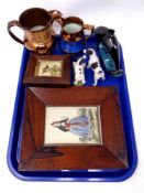 A tray containing copper lustre jugs, pottery dolphin, two dog statues,