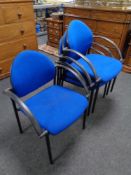 A set of four office stacking armchairs upholstered in a blue fabric