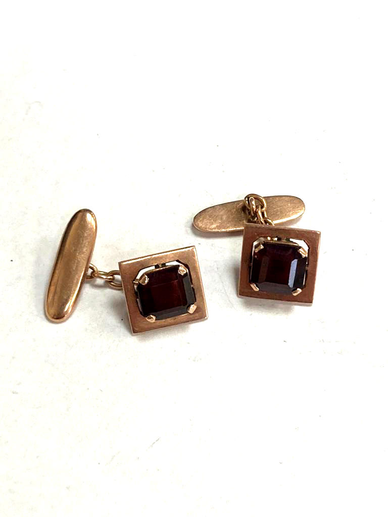 A pair of 14ct gold cufflinks set with garnets CONDITION REPORT: 7.