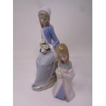 A Lladro figure : Girl seated with Lilies together with a further Lladro figure of a girl kneeling.