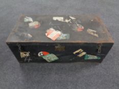 An antique tin shipping trunk bearing labels