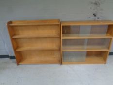 A set of mid 20th century sliding glass door bookshelves together with a further set of open