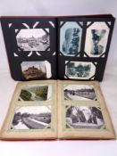 Two albums containing a large quantity of antique and later monochrome and colour tourist post