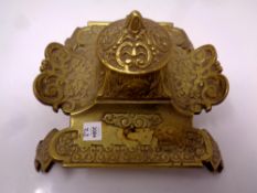 A decorative brass inkwell