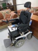 A Puma 40 electric wheelchair with accessories and instructions, seat restraint,