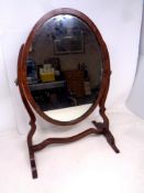 A 19th century oval mahogany swing dressing table mirror on stand. Height 46.