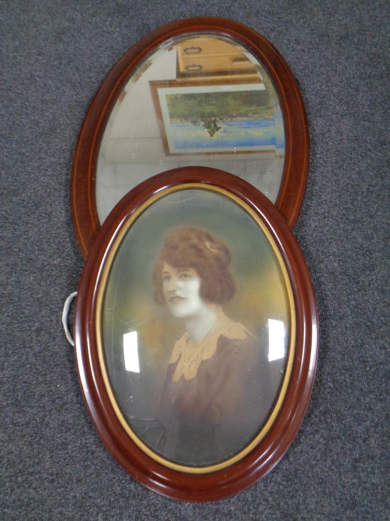 A 19th century oval inlaid mahogany framed bevel edged wall mirror together with a further 19th