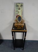 A contemporary black and gilt plant stand,