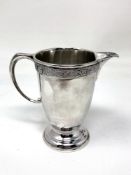 A Lindisfarne silver cream jug, Reid & Sons, London marks, height 10cm.