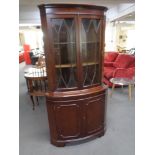 A double door corner display cabinet fitted cupboards beneath