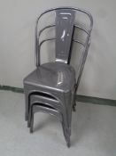 A set of three metal stacking French style cafe chairs
