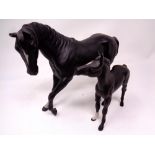 Two Beswick figures of a stallion and foal in black matte finish