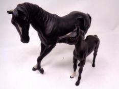 Two Beswick figures of a stallion and foal in black matte finish