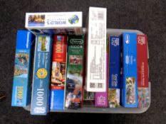 A box containing a quantity of jigsaw puzzles
