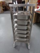 A stainless steel commercial Bain Marie trolley with lidded Bain Marie pots,