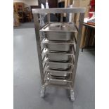 A stainless steel commercial Bain Marie trolley with lidded Bain Marie pots,