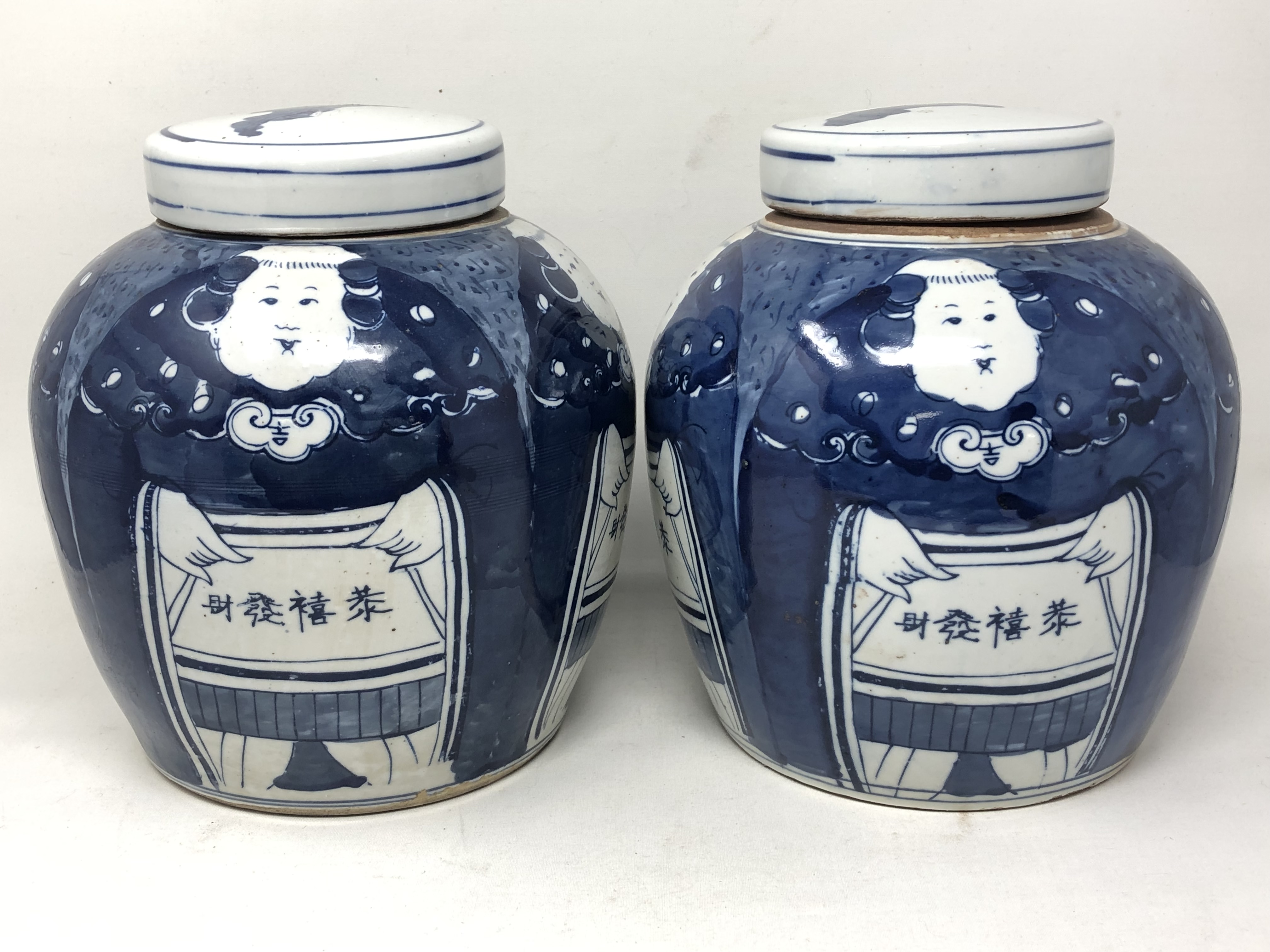 A pair of Chinese blue and white lidded temple jars,