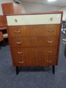 A mid 20th century teak two tone five drawer chest