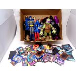 A box containing superhero figures together with a quantity of trading cards including Pokemon,