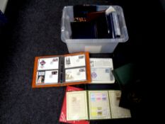 A crate containing a large quantity of folders and albums of stamps and first day covers.