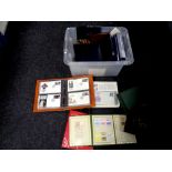 A crate containing a large quantity of folders and albums of stamps and first day covers.