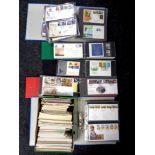 A box containing several folders of first day covers