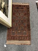 An Afghan rug 55 cm x 107 cm