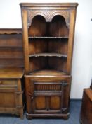 A Titchmarsh & Goodwin oak corner cabinet retailed by Chapman's